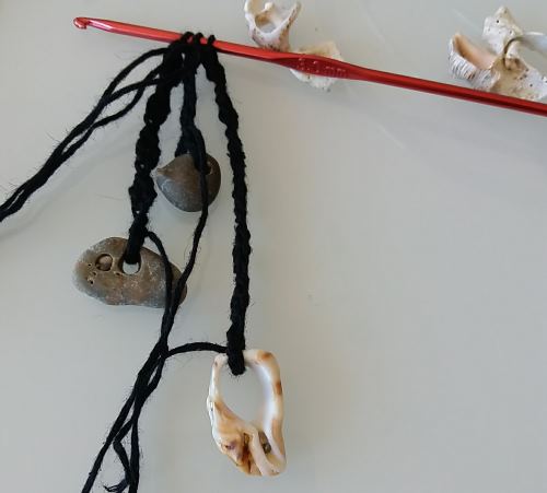 Har du hittat fina stenar och snäckskal på stranden? Då kan du virka ett halsband med semesterminnen.